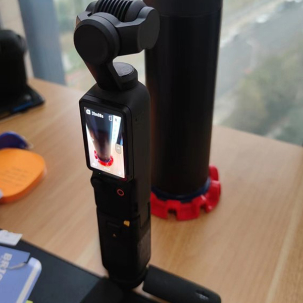 Dnoodle system on a desk holding an insulated drink bottle.
