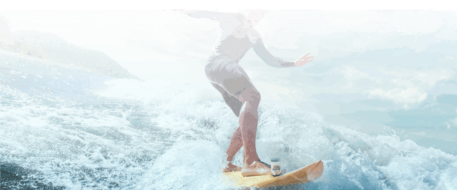 Dnoodle system mounted on a surfboard riding through small waves.